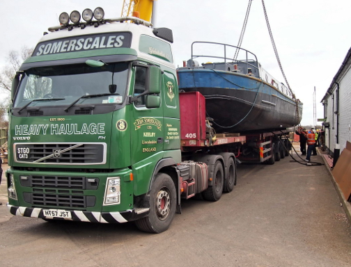 Yacht being carefully loaded onto a lorry